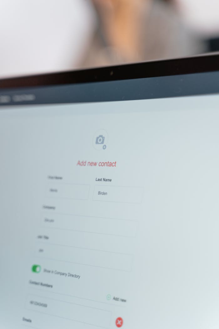 Close-up of a computer screen with an open contact form for adding a new entry.